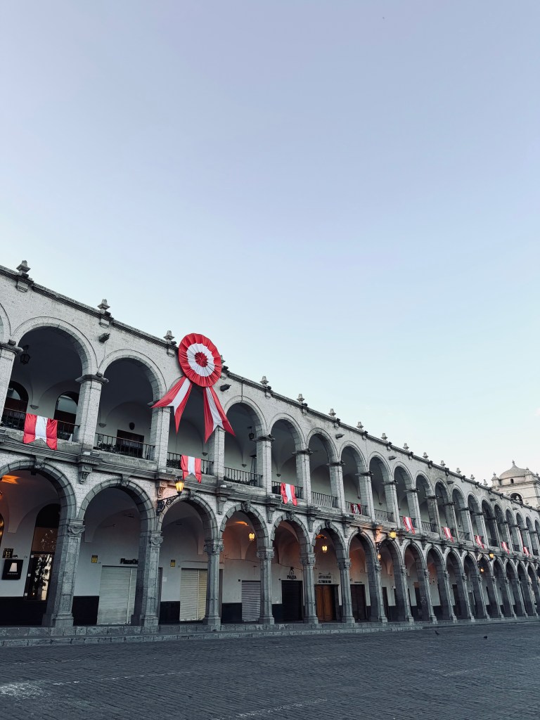 Old style square with Peru flags in Plaza de Armas in Arequipa, Peru