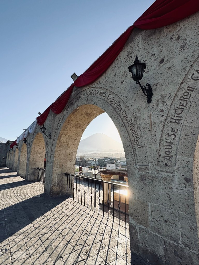 Famous archways with volcano in background at Yanahuara lookout in Arequipa, Peru