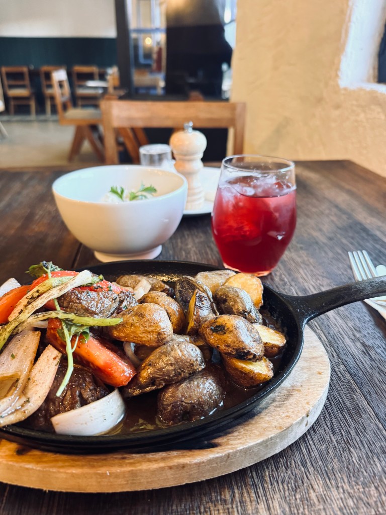 Lomo Saltado peruvian dish served in a hot pan in a restaurant in Cusco, Peru