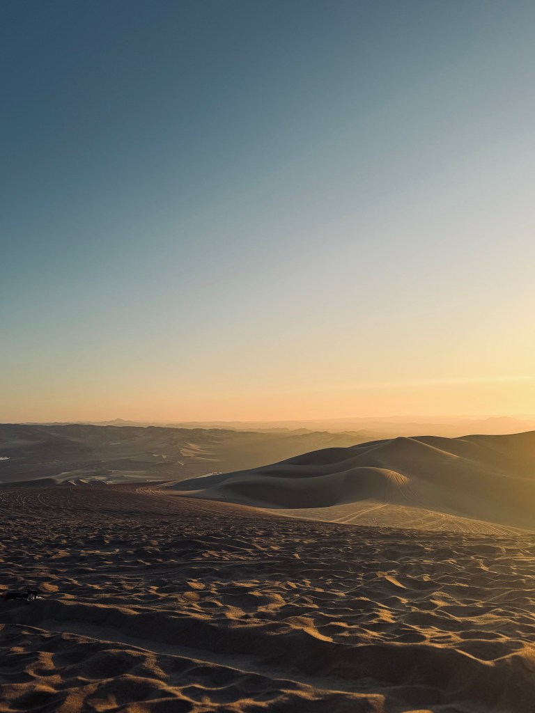 Sunset over sand dunes in Huacachina, Peru