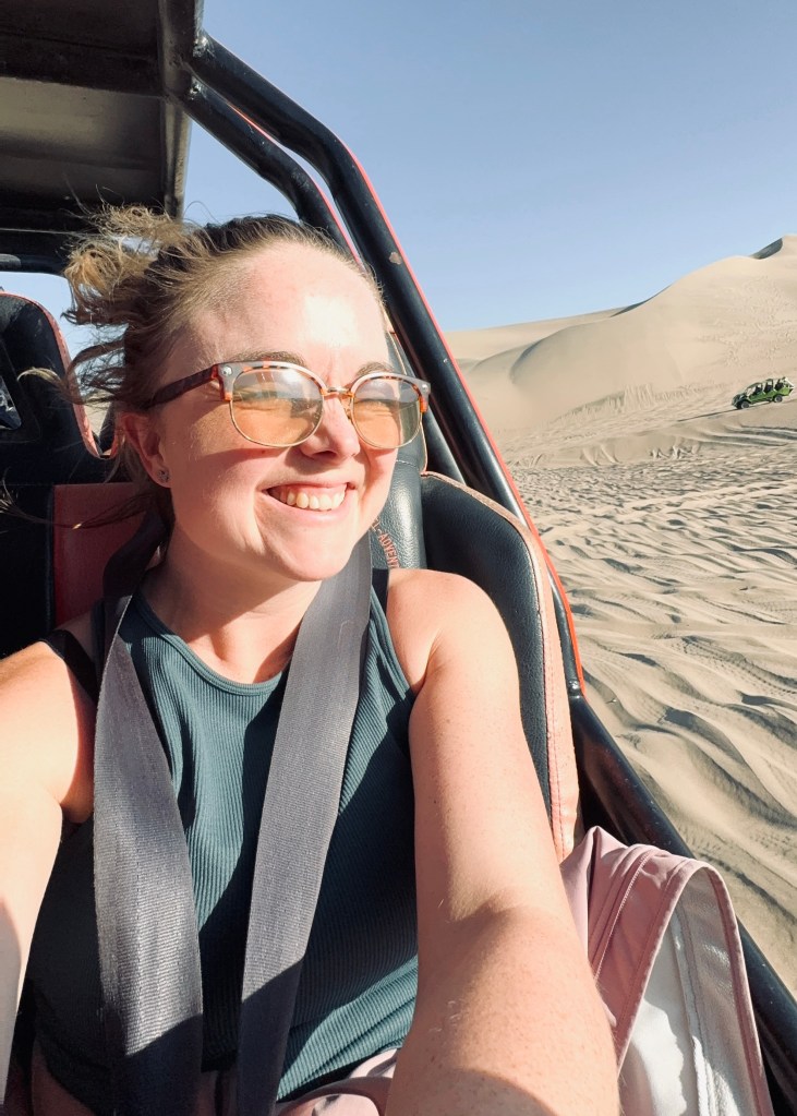 Girl taking selfie on dune buggy in Huacachina, Peru