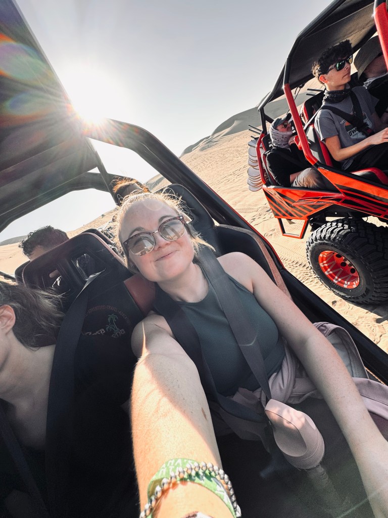 Girl taking selfie in dune buggy in Huacachina, Peru