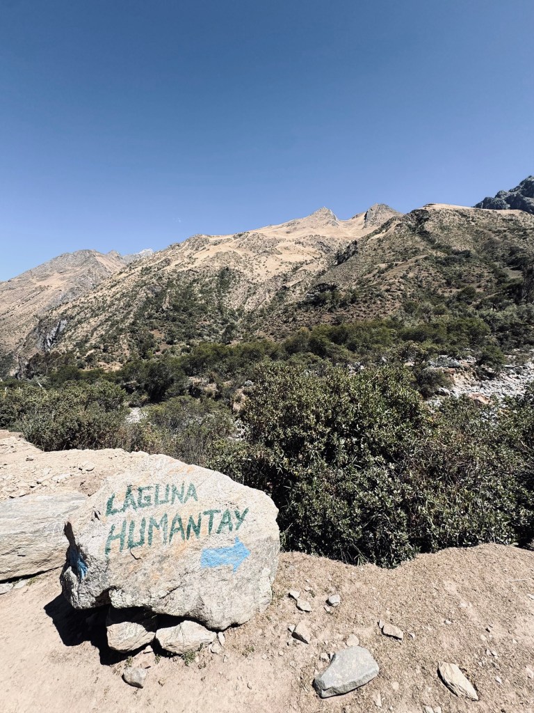 Laguna Humantay sign painted on a rock with an arrow in Peru