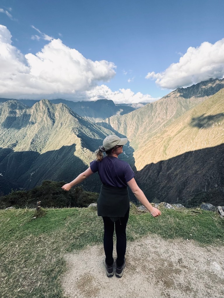 Girl looking out at green mountain views on the Inca Trail in Peru