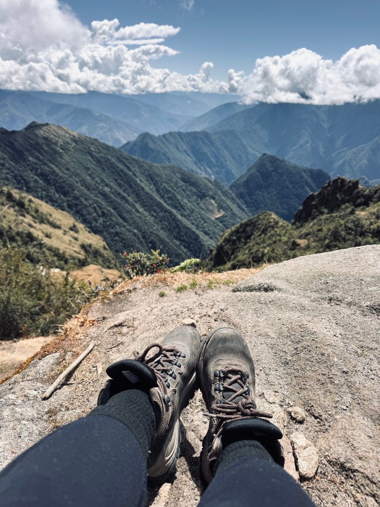 Hiking boots with mountains in the background on the Inca Trail in Peru