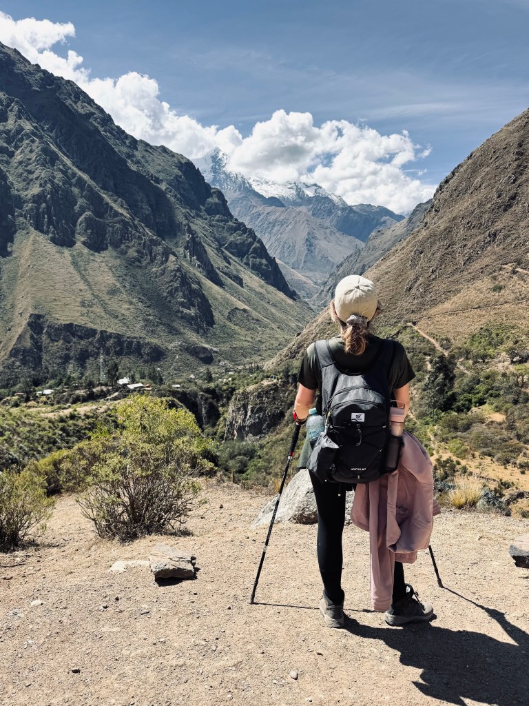 Girl with hiking poles looking out at mountains on the Inca Trail, Peru