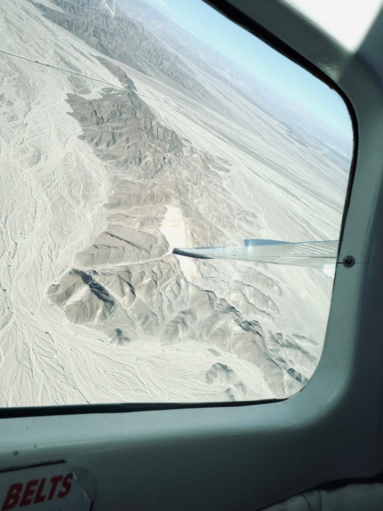 View of mountains out of a plane window on a Nazca Lines flight tour in Nazca, Peru