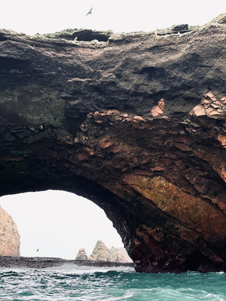 Natural arch with ocean and rock formations in Islas Ballestas in Paracas, Peru.