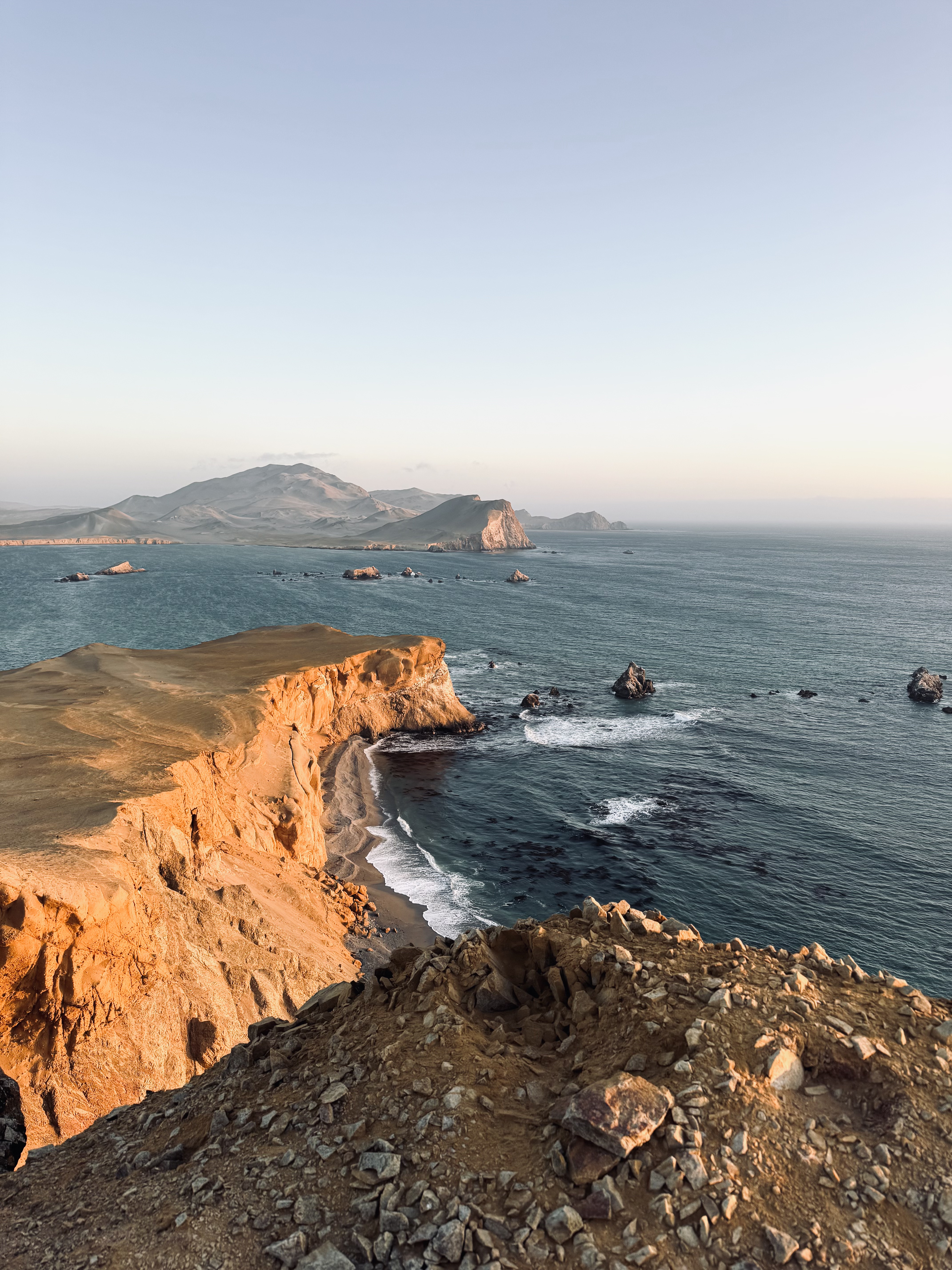 Golden hour over cliff formations in Paracas National Reserve, Peru