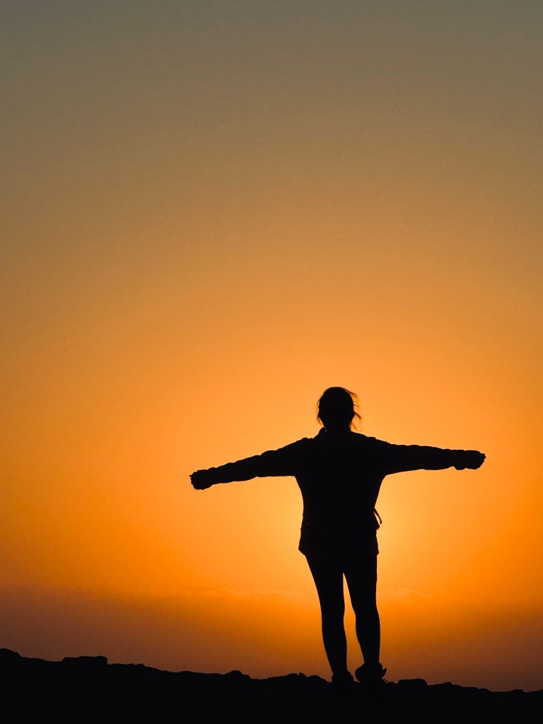 Girl silouette at sunset at Paracas National Reserve, Peru