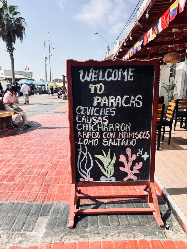 'Welcome to Paracas' restaurant sign in Paracas, Peru