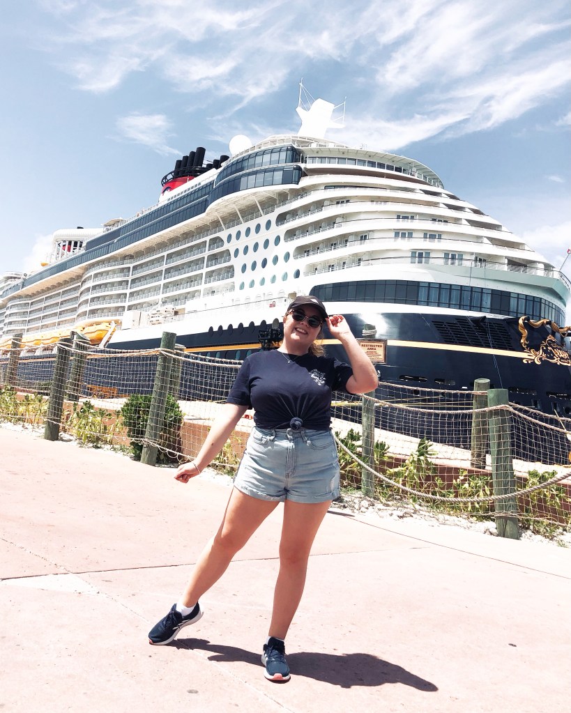 Girl posing in front of Disney Wish cruise ship
