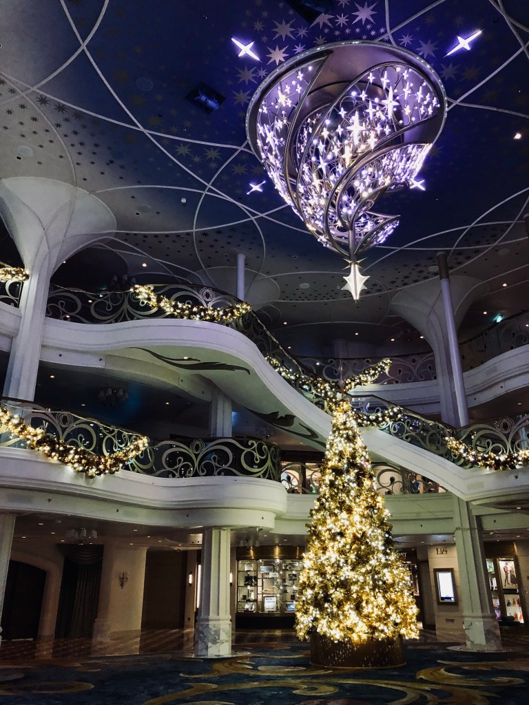 Grand Hall onboard the Disney Wish with christmas tree all lit up for the holidays
