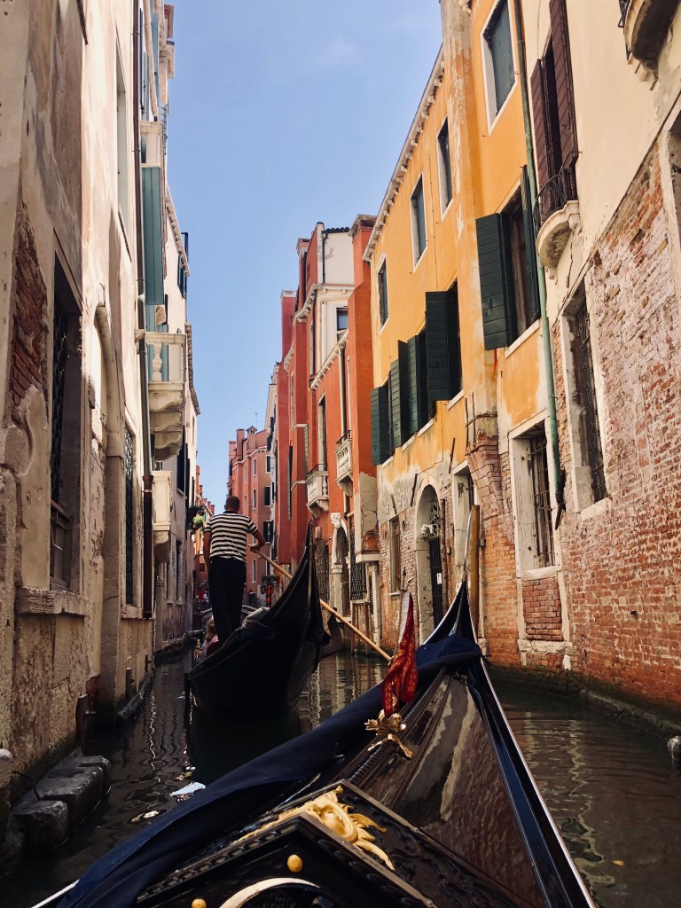 Gondolas floating through the canals and old buildings in Venice, Italy