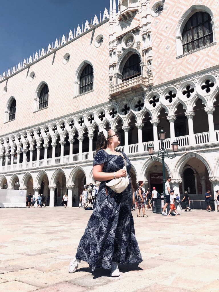 Girl looking out at Piazza San Marco on a sunny day in Venice, Italy