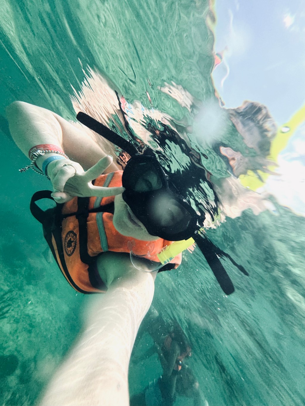 Girl with lifejacket snorkelling at Akumal Beach in Mexico