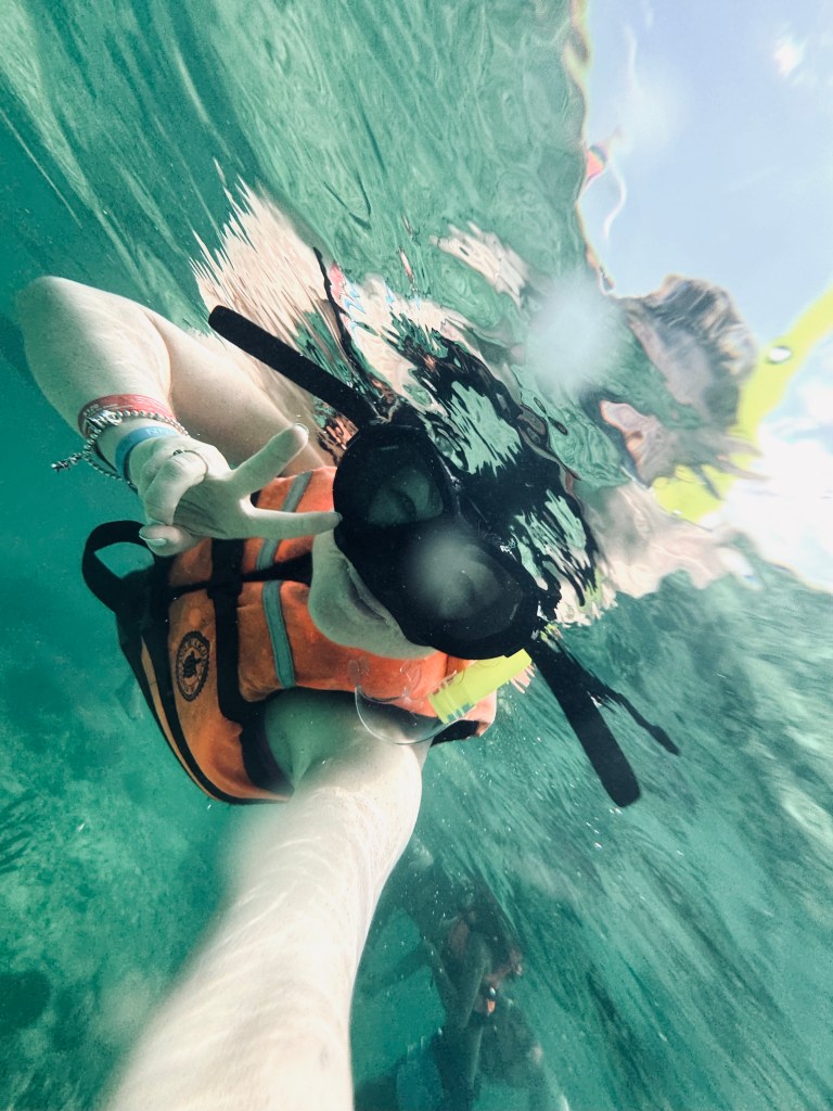 Girl with lifejacket snorkelling at Akumal Beach in Mexico