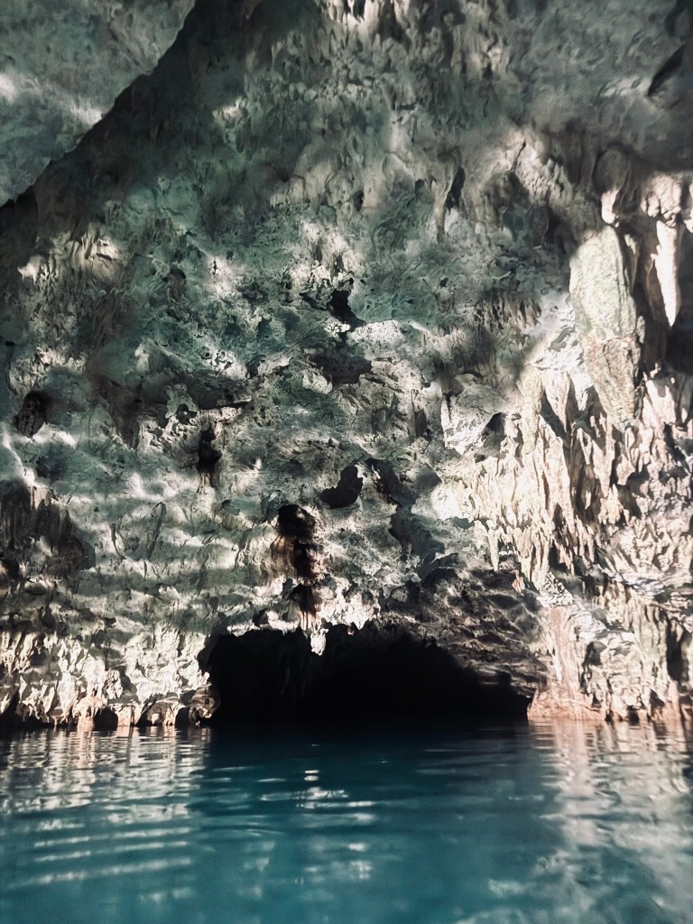Blue water with entrance to a cave at Cenote Tak Be Luum, Mexico