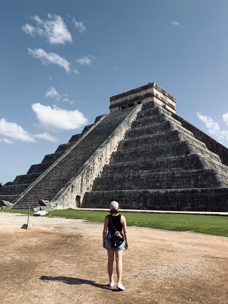 Girl walking towards Chichen Itza, Mexico