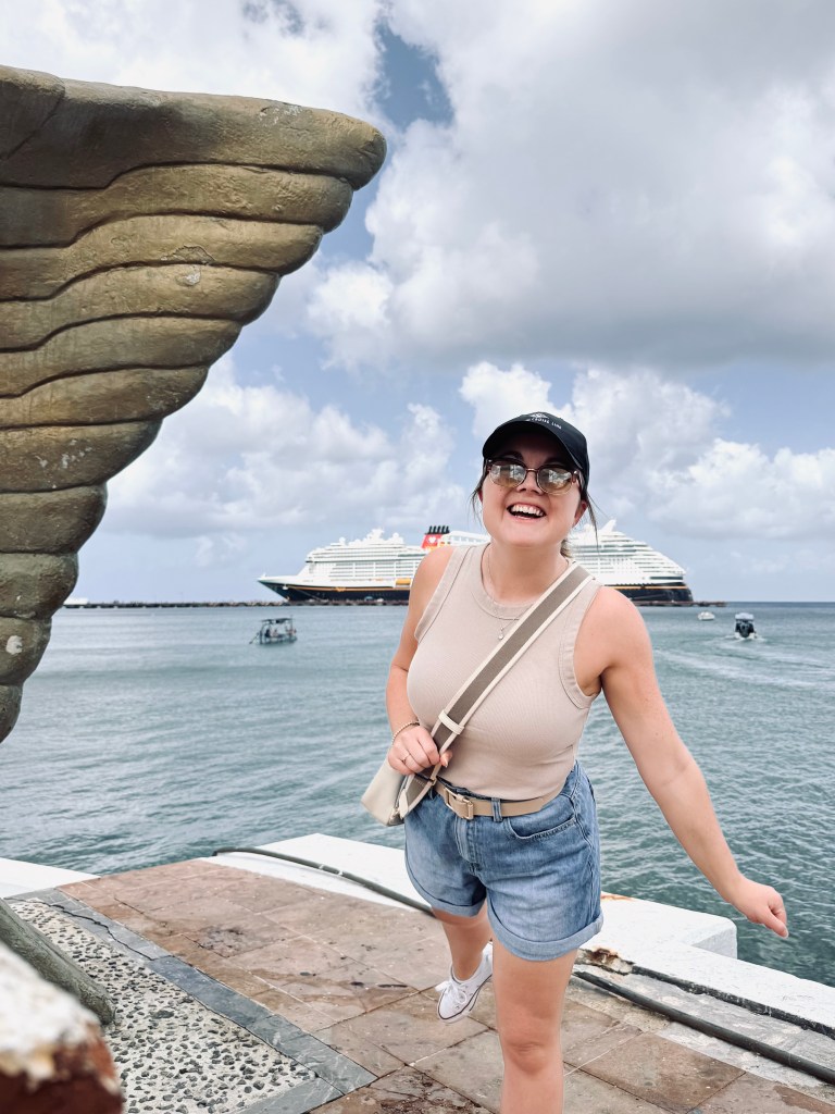 Girl smiling in front of cruise ship at Cozumel, Mexico