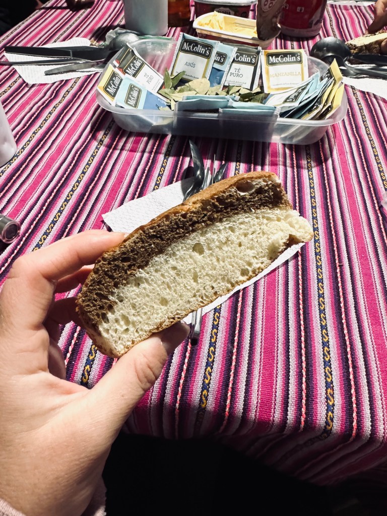 Hand holding homemade bread for breakfast on the Inca Trail, Peru