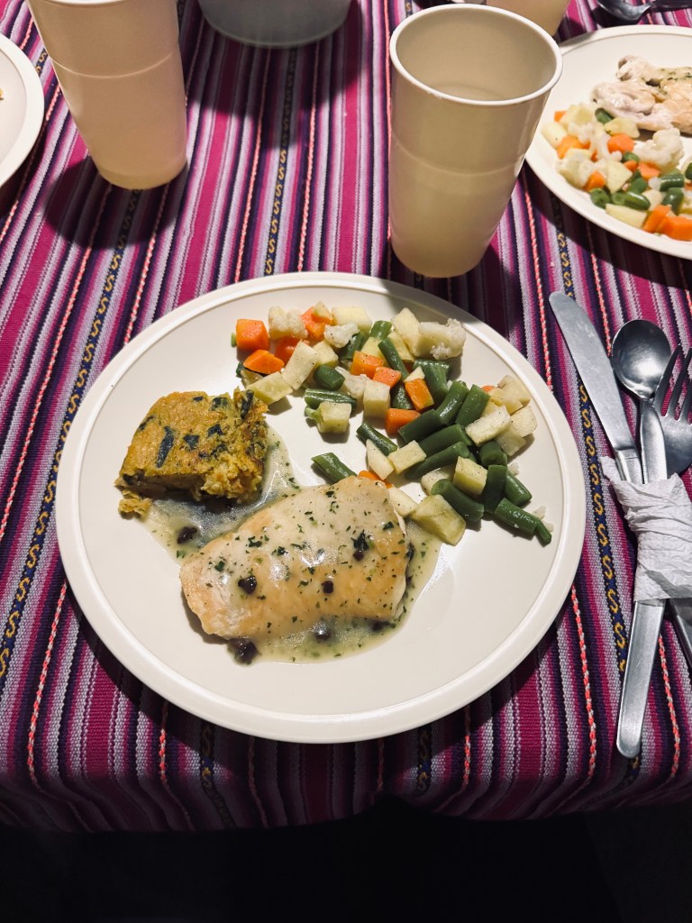 Plate of grilled chicken and vegetables for dinner on the Inca Trail, Peru