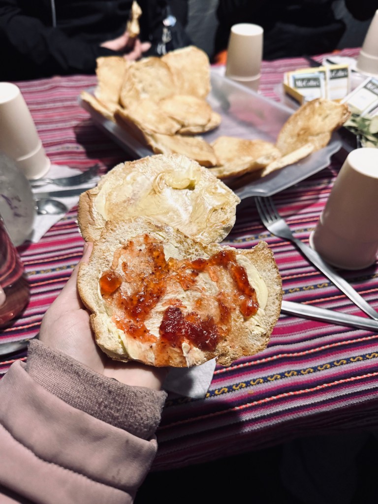 Hand holding jam toast for breakfast on the Inca Trail, Peru