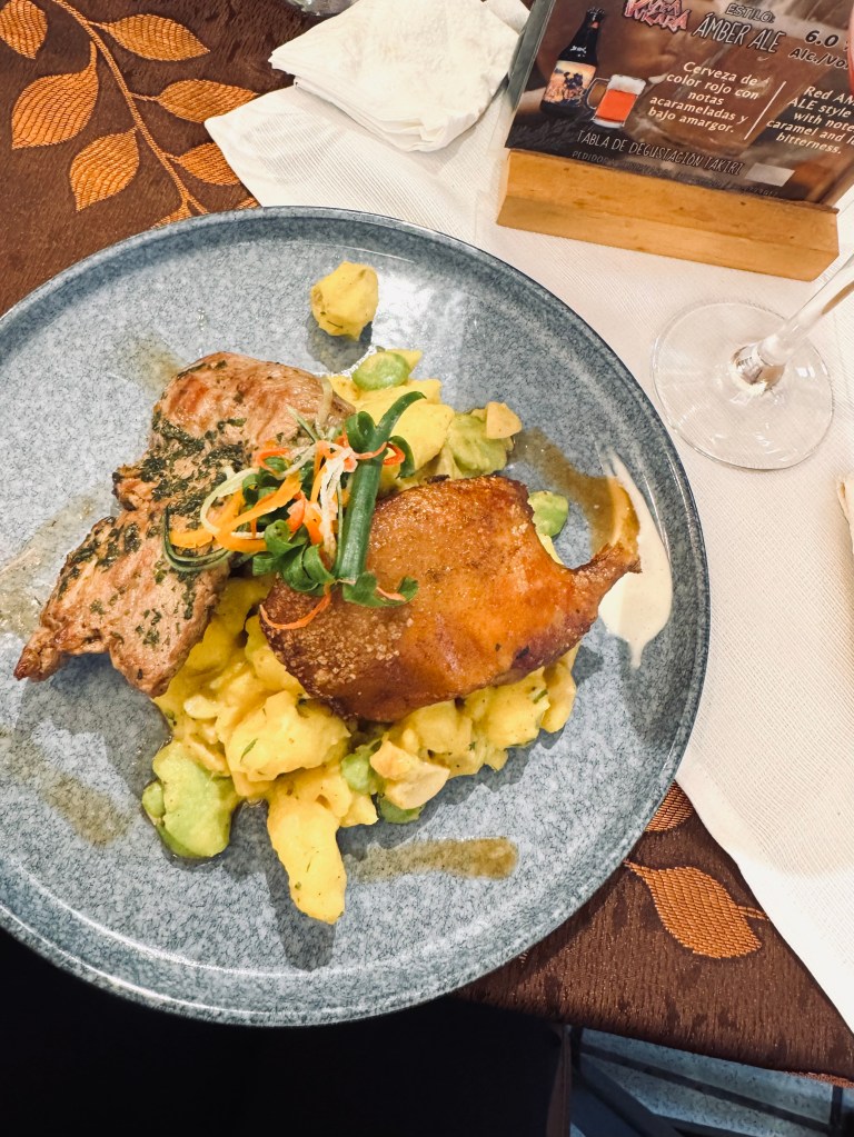 Plate of peruvian food - alpaca meat and guinea pig for lunch in Peru