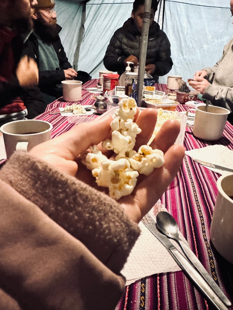 Hand holding popcorn for tea time on the Inca Trail, Peru