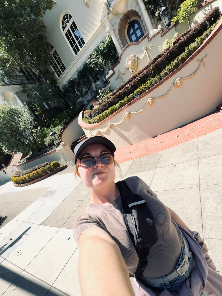 Girl taking selfie with house used to film Princess Diaries school in San Fransisco, USA