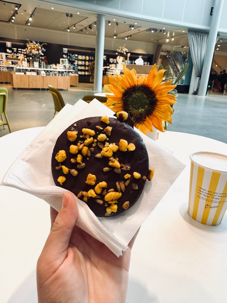 Hand holding chocolate cookie with yellow sprinkles in Amsterdam, The Netherlands