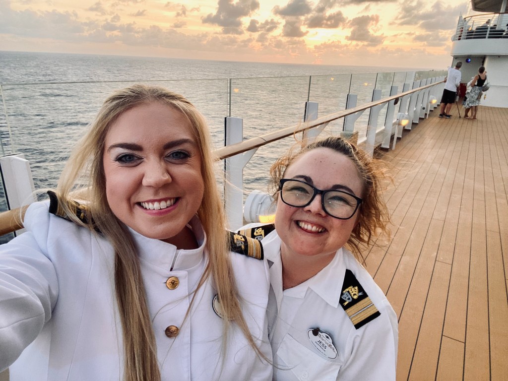 Two disney cruise line officers taking a selfie on deck