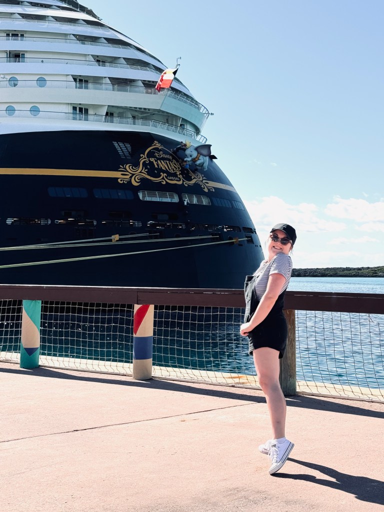 Girl smiling in front of Disney Fantasy cruise ship