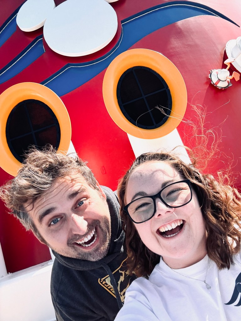 Two friends taking selfie in front of mickey funnel