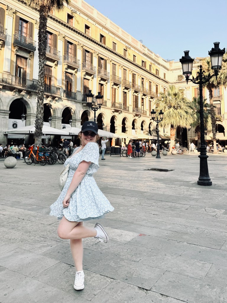 Girl in summer dress smiling in old town of Barcelona, Spain
