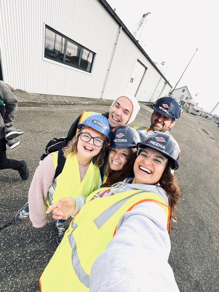 Disney Cruise Line crew members wearing high vis vest and hard hats at a shipyard in Eemshaven, The Netherlands