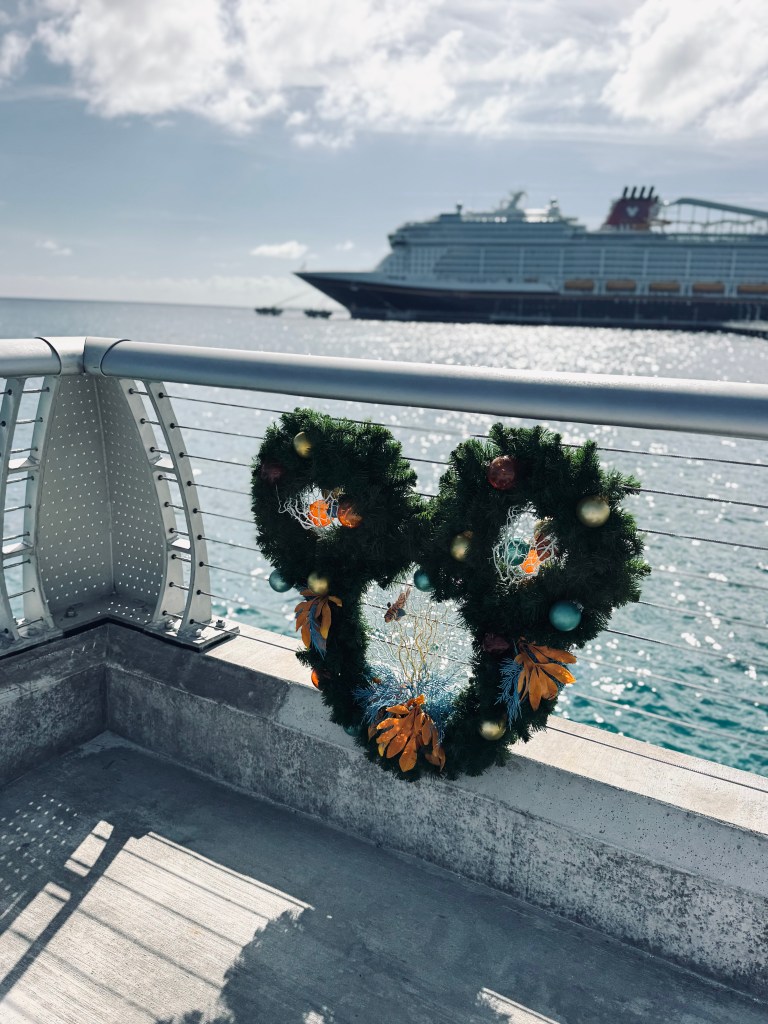 Holiday wreath with disney ship in background at Lookout Cay at Lighthouse Point on a Disney Cruise in the Bahamas