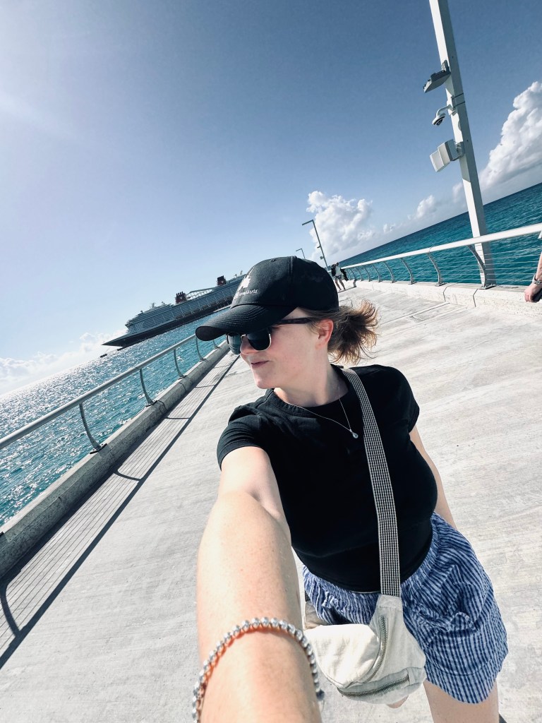 Girl taking selfie while walking along pier at Lookout Cay at Lighthouse Point on a Disney Cruise in the Bahamas
