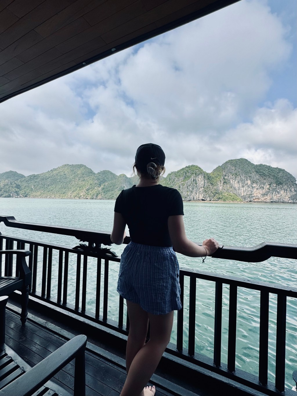 Girl looking out at balcony on a Halong Bay cruise, Vietnam