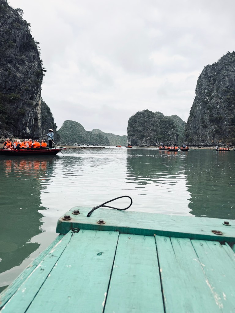 Bamboo boat with limestone islands in background on a Halong Bay cruise, Vietnam