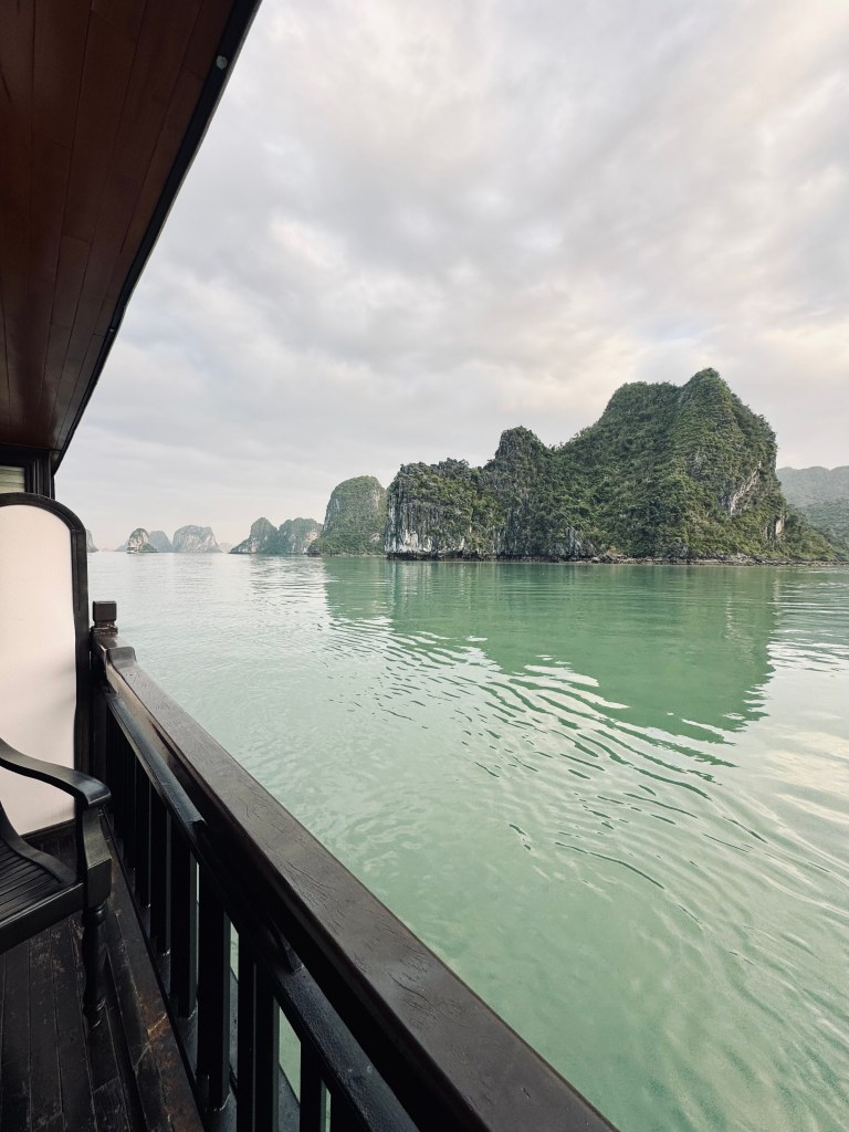 Limestone islands with green ocean water on a Halong Bay cruise, Vietnam
