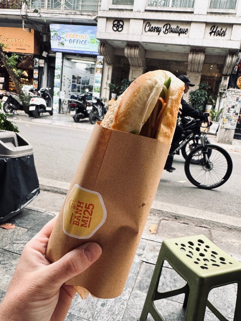 Hand holding Banh Mi sandwich in Hanoi, Vietnam