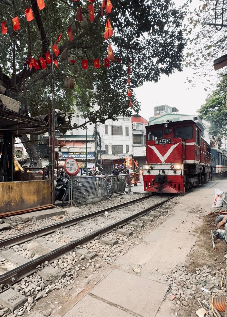 Moving train approaching on Train Street in Hanoi, Vietnam