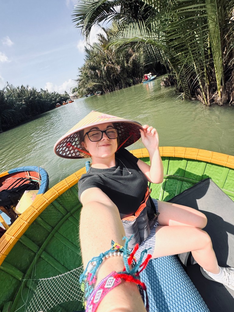 Girl on a coconut Boat ride in Ancient Town of Hoi An, Vietnam