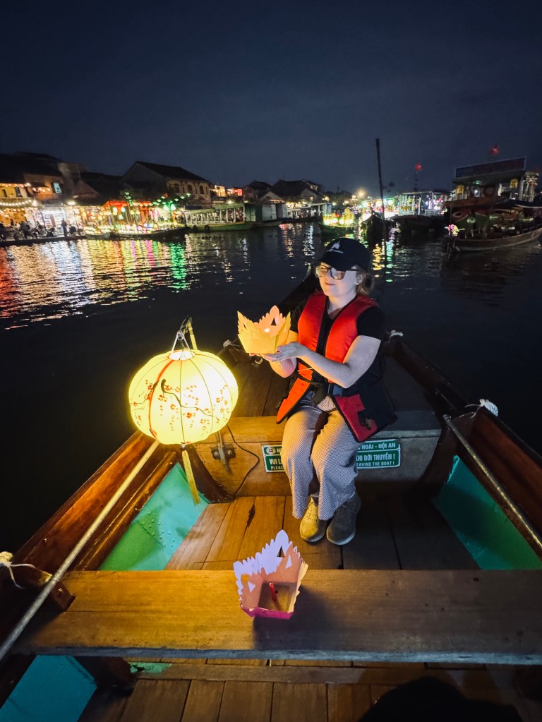 Girl on lantern boat ride in Ancient Town of Hoi An, Vietnam