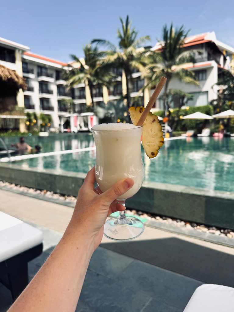 Hand holding cocktail at a resort of Hoi An, Vietnam