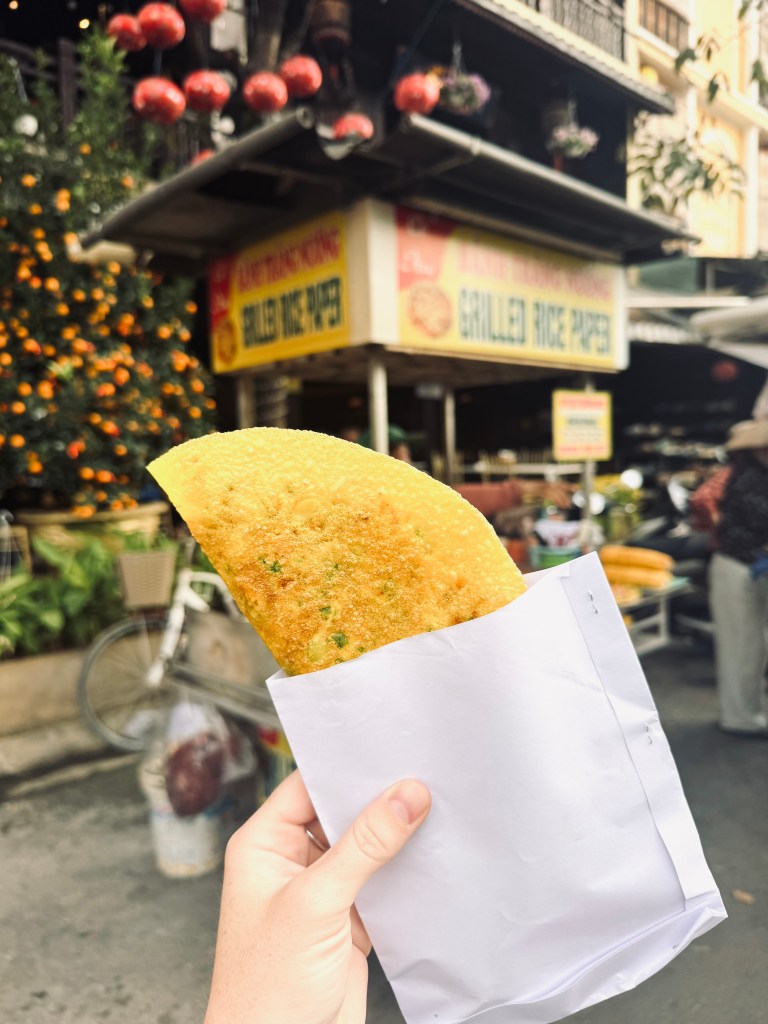 Hand holding street food in Ancient Town of Hoi An, Vietnam