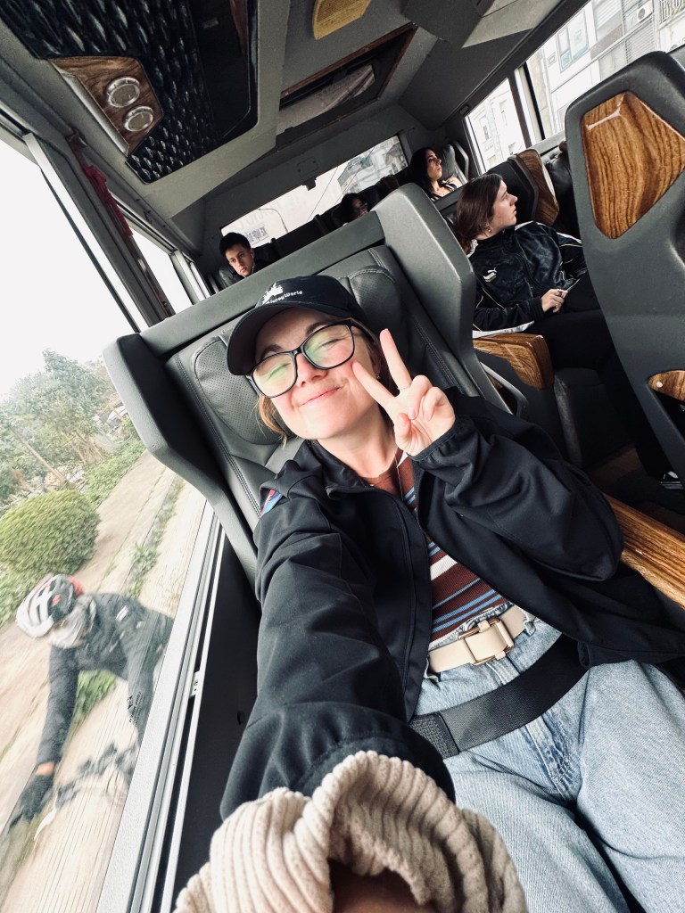 Girl taking selfie on a limousine bus recliner chair in Vietnam