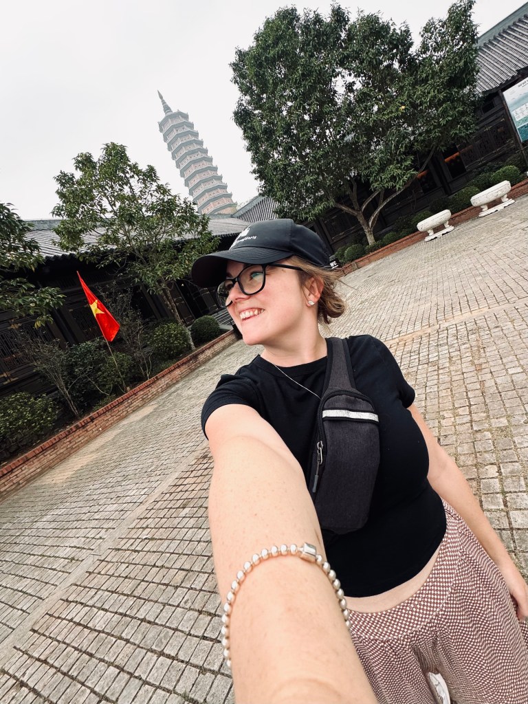 Girl taking selfie in front of Bai Dinh pagoda in Ninh Binh, Vietnam