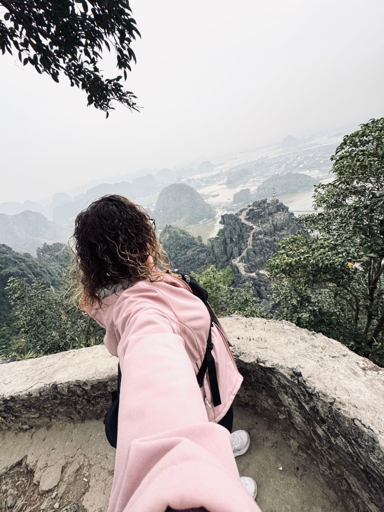 Girl taking selfie at the top of Mua Cave hike in Ninh Binh, Vietnam